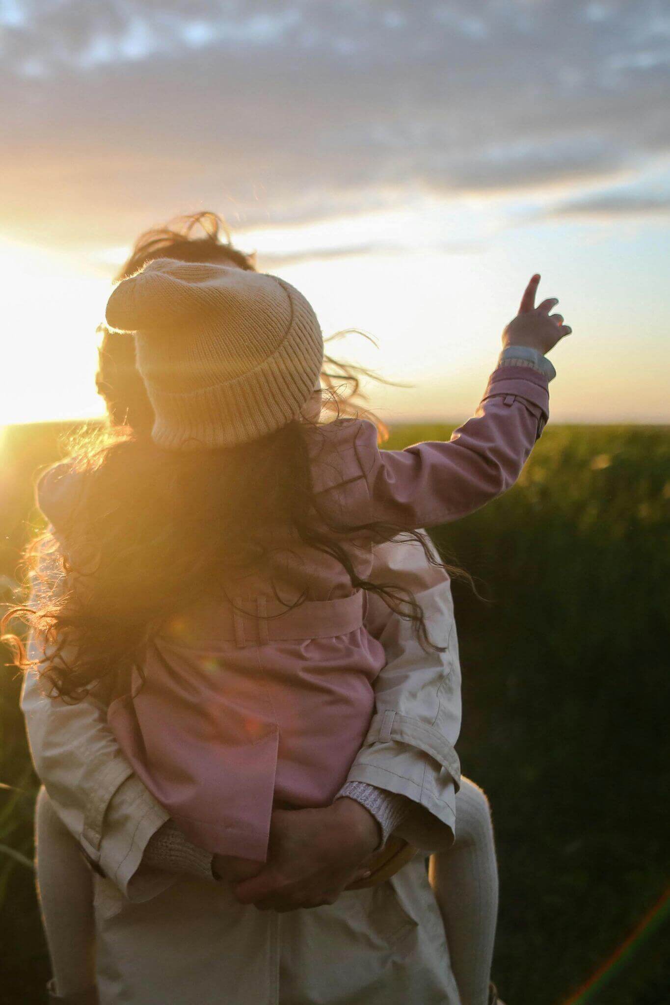 Parent and child in sunset
